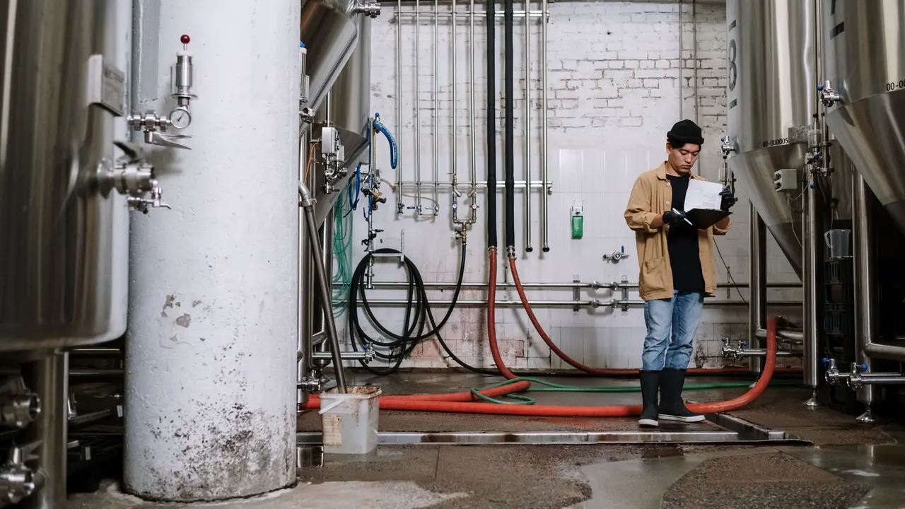 Plumber inspecting home plumbing during a maintenance visit