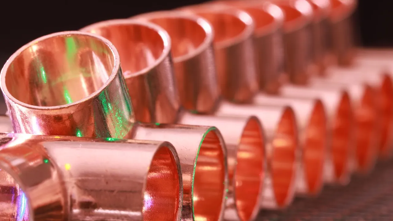 Copper, PEX, and CPVC pipes side by side on a workbench