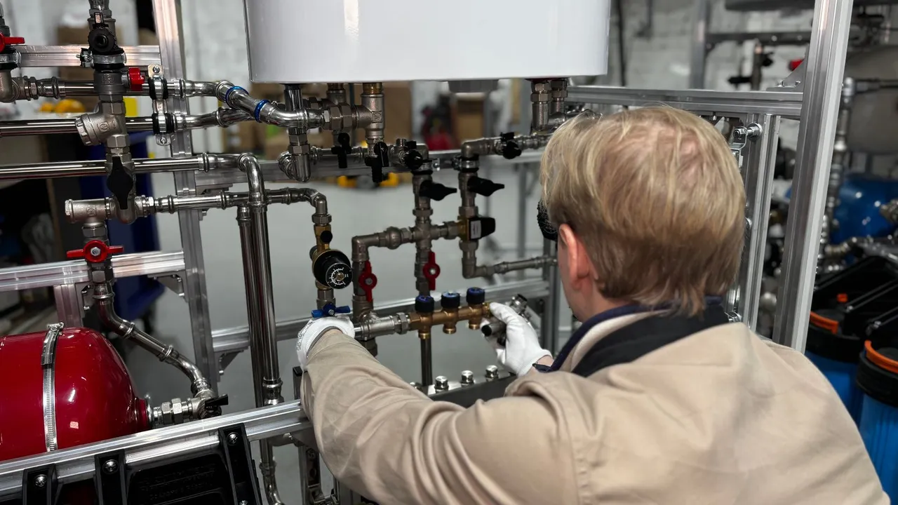 Plumber checking water pressure with a gauge on a home supply line
